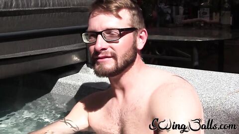 Gay with glasses shows balls before masturbating with buddy
