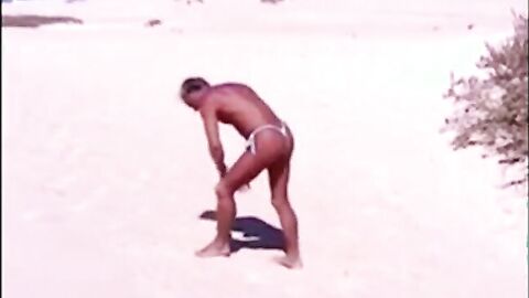 Tanned guy on beach in tiny string thong (temporarily!)