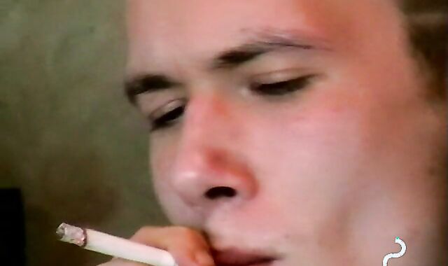 Hot dude stroking his huge dick and enjoys smoking butts