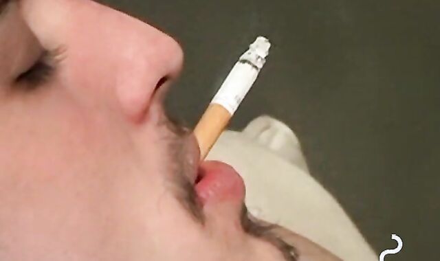 Axel loves pleasing his big dick with a blow of smoke