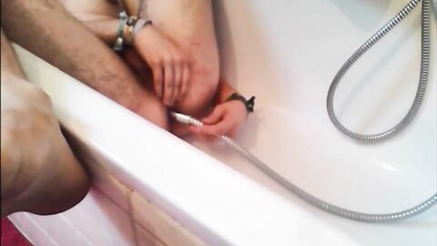 Bi-guy using shower head, squirting water, enema