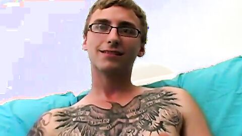 Geeky amateur with glasses and tattoos strokes his big cock