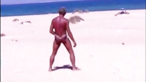 Tanned guy on beach in tiny string thong (temporarily!)