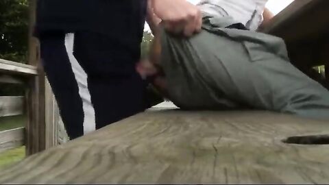 Bareback anal cumming on an outdoor bench.