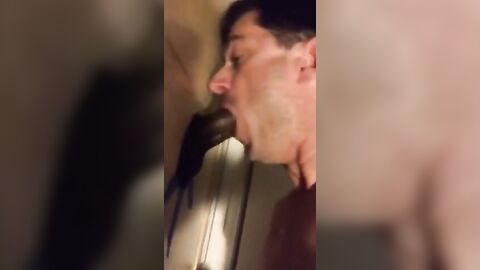 Amateur sucks big black cock at glory hole