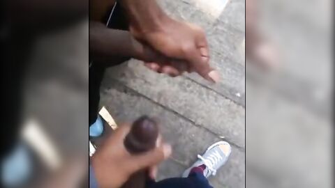 Black amateurs stroke big cocks outdoors
