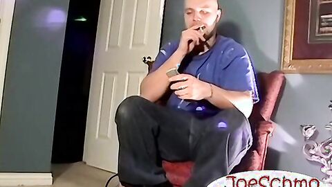 A bald black dude with a massive cock rubbing it til he cums