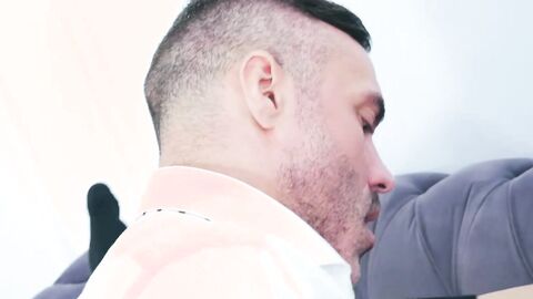 Suited Marcos Oliveira sits and rides the big cock of hairy Manuel Skye