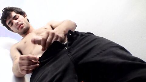 Attractive twink thug strokes his hairy dick and cums solo