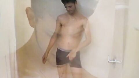 Sexy Bleu is blowing smoke and stroking his cock in the while taking a shower