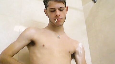 Sexy Bleu is blowing smoke and stroking his cock in the while taking a shower