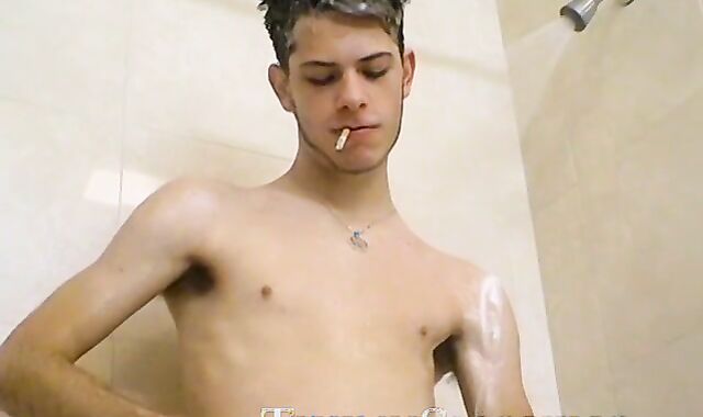 Sexy Bleu is blowing smoke and stroking his cock in the while taking a shower