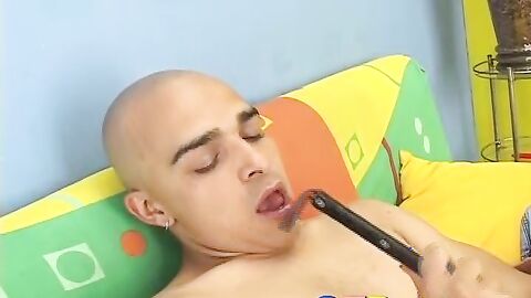 Kinky skinhead latino Cristobal is on the sofa wanking dick