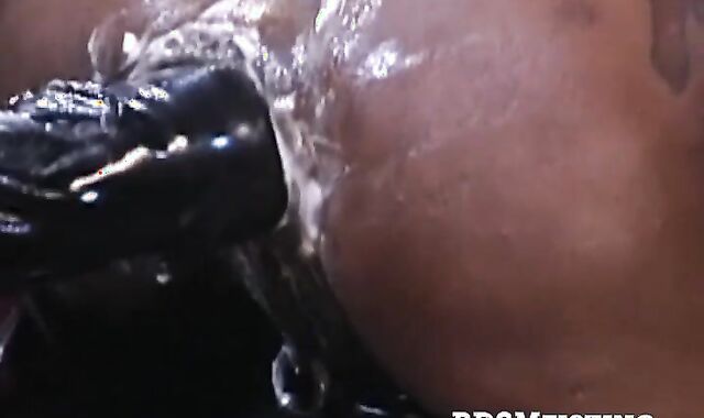 Over on a red workbench, Michael Brandon dives full-on into Simon Cox's stunning ass.