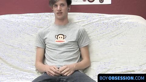 On a couch by himself cute gay man Danny jerks off his dick