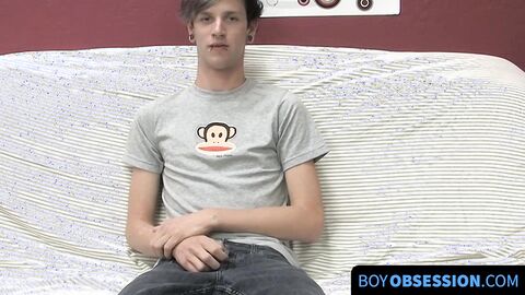 On a couch by himself cute gay man Danny jerks off his dick