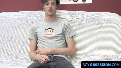 On a couch by himself cute gay man Danny jerks off his dick