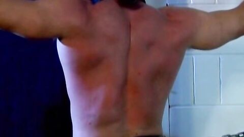 Muscled Derek Pain takes flogging all over his sexy back til it is rosy red