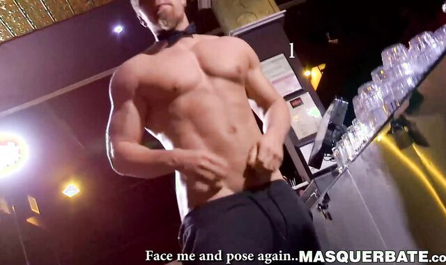 Buff stud strips nude to masturbate passionately behind bar