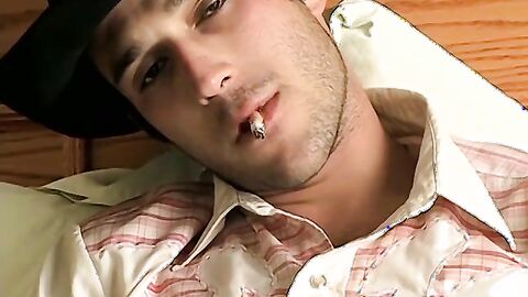 Hottie Cody lights his red cig while stroking his pinkish cock