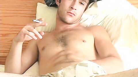 Hottie Cody lights his red cig while stroking his pinkish cock