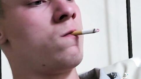 Twink savors the pleasure of smoking and stroking cock